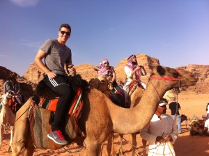 Riding a camel through Wadi Rum, Jordan