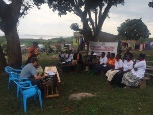 Conducting interviews with Solar Sitsers who are part of the Sango Bay Farmers) Association