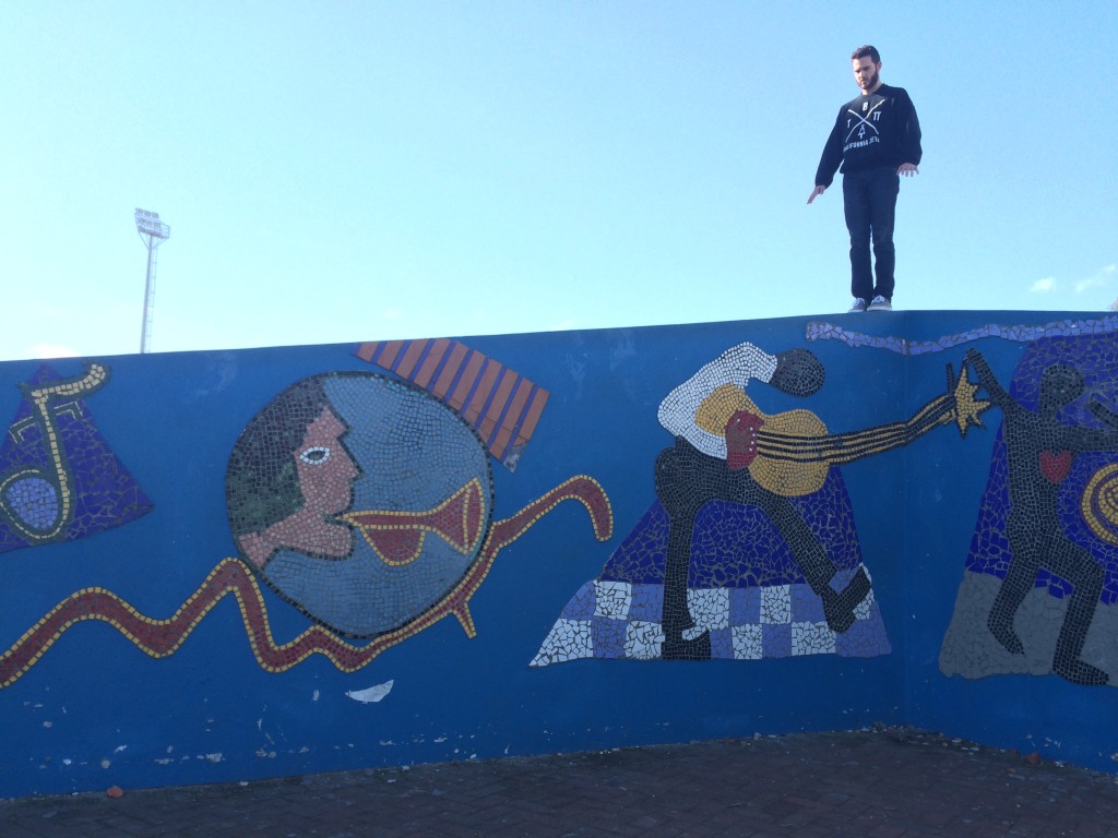 Jake climbing the beautiful mosaic wall at the Nyanga branch, the Zolani Centre