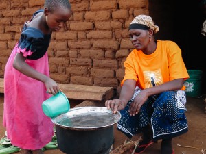 Moshi and her daughter prepare dinner using her clean cookstove