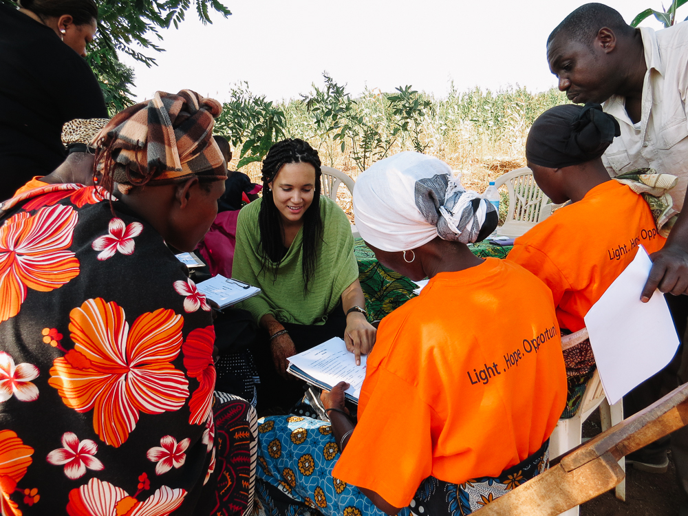My research partner, Lindsey, assists Solar Sister entrepreneurs as they fill out our survey.