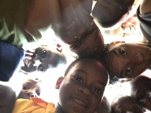 Children at a Ugandan school took a picture who took silly pictures with me and are the beneficiaries of an improved healthcare system