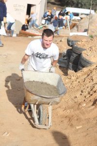 Day 1 of house building involved laying the foundation by mixing cement, which was downhill.