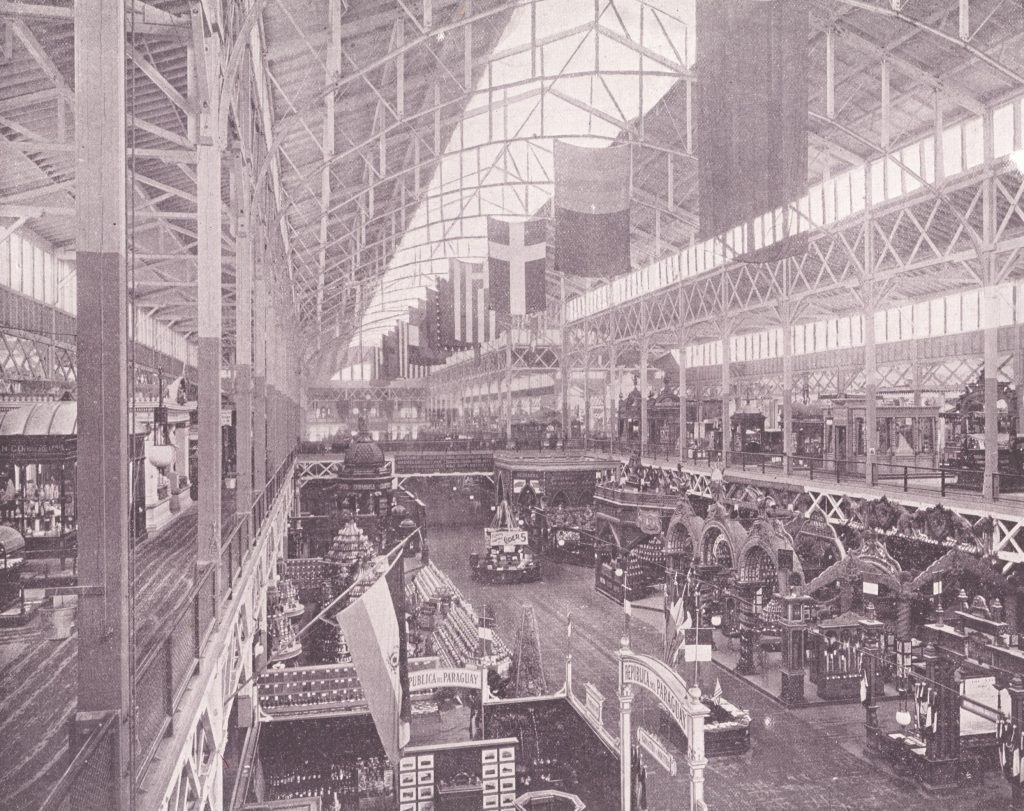 international flags and exhibits are set up in the very spacious Manufactures building with very wide walkways and very high ceilings