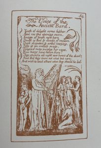 A man playing a harp with people surrounding him. The poem above the illustration is called: The Voice of the Ancient Bard.
