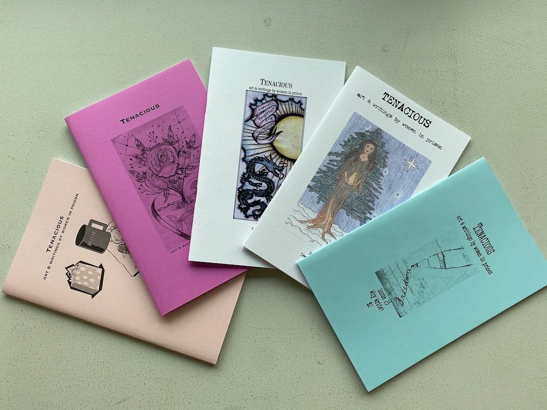 5 different editions of Tenacious spread out on a table