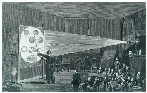 Lecture hall with projector and Jesuit science instructor