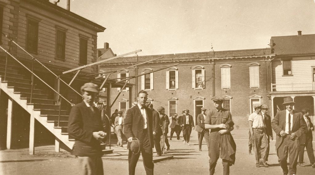 Students walking in casual clothes surrounded by buildings