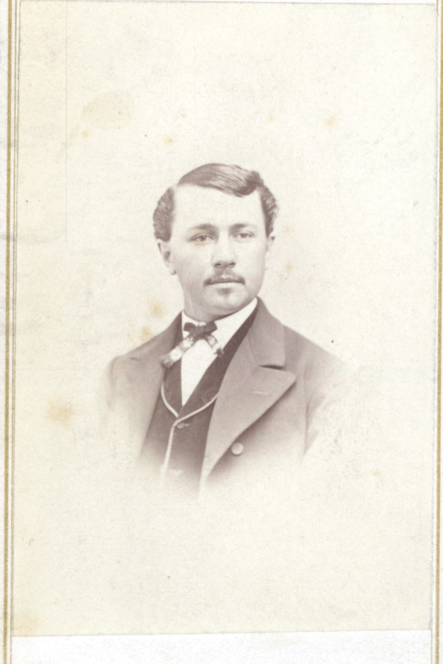 A portrait of a man wearing a suit and bowtie.