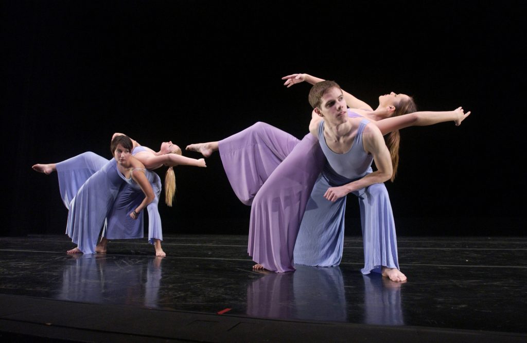 Modern dance students in pale blue and lavender outfits.