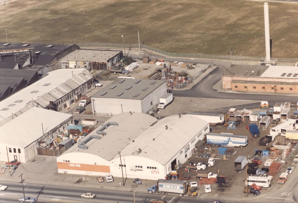 Aerial view of the Alameda showing a warehouses surrounded by parking lots.