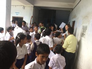 Nate and Erika are swarmed at a school for autographs. 