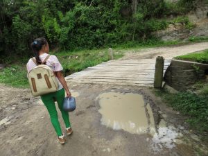 A girl holding a jug of juice.