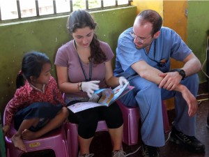 Reading to a little girl in a school located on an active landfill in Cambodia 
