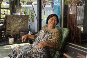 A woman sits with us, sharing her story and experience with water purification