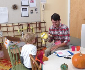 Andrew (and puppet) playing word games