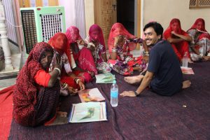 These working women wanted to leave work to be able to take care of their household. The craft manager training that these women were attending had a mandatory in-residence component, and despite this, their husbands let them attend. That being said, women sought to return home, showing that responsibilities at home were something they enjoyed and respected. In this photo, the women are struggling to convince Avesh, the operations manager at the Barmer site, to let them return home for a few hours of household work. 